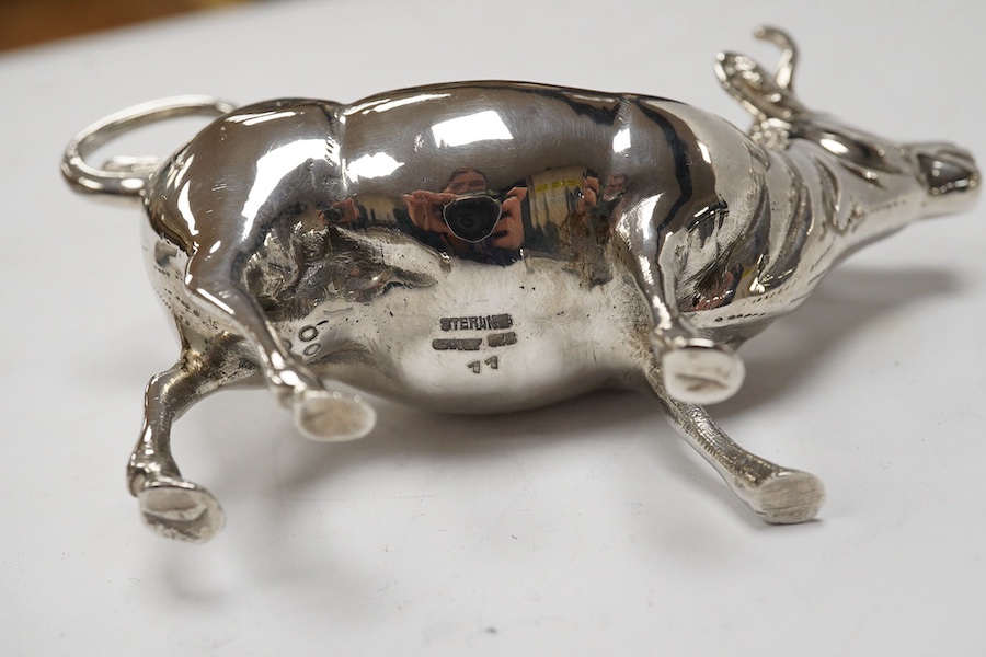 Assorted small silver including a cigarette case, set of four Victorian salts by Thomas Bradbury & Sons, London, 1878, a sterling cow creamer and three condiments. Condition - fair to good